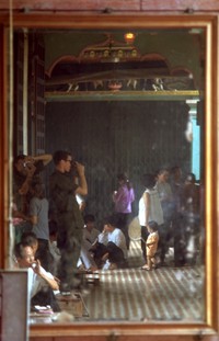 Alex and Gary Smith dodging downpour by taking pictures inside a handy building 1970
