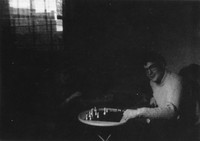 Alex at chess with someone somewhere