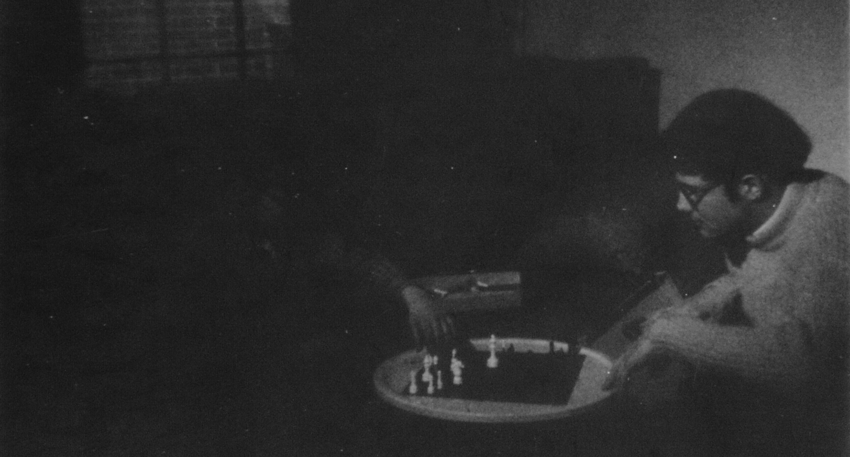 Alex at chess with someone somewhere